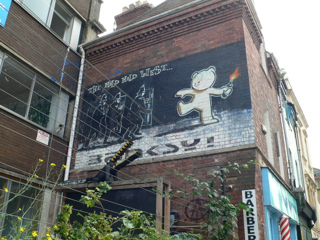 The Mild Mild West, Stokes Croft, Bristol — a teddy bear hurling a Molotov cocktail at three riot police.